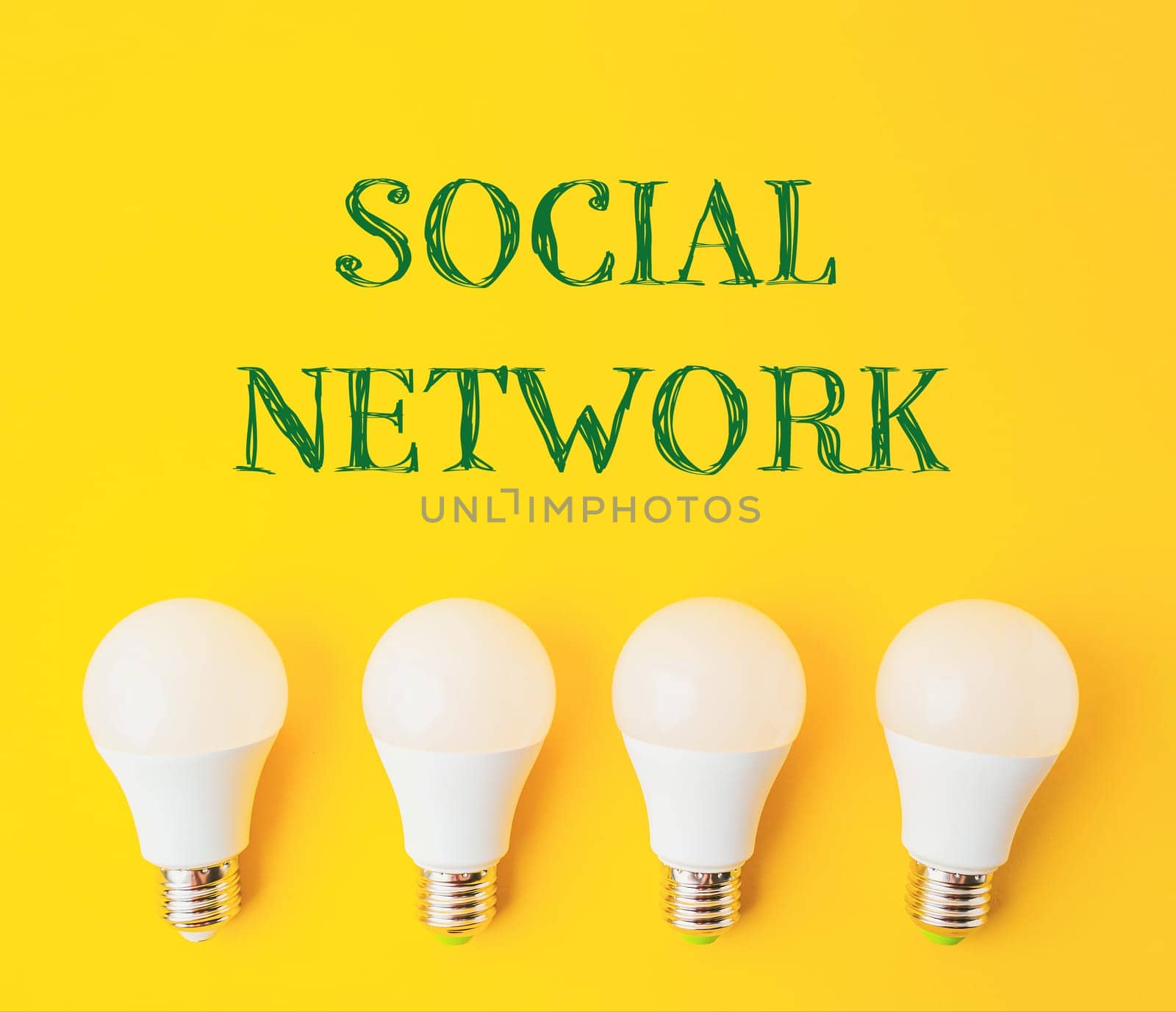 A group of four white light bulbs with the word social network written above them. Concept of unity and collaboration, as the bulbs are grouped together
