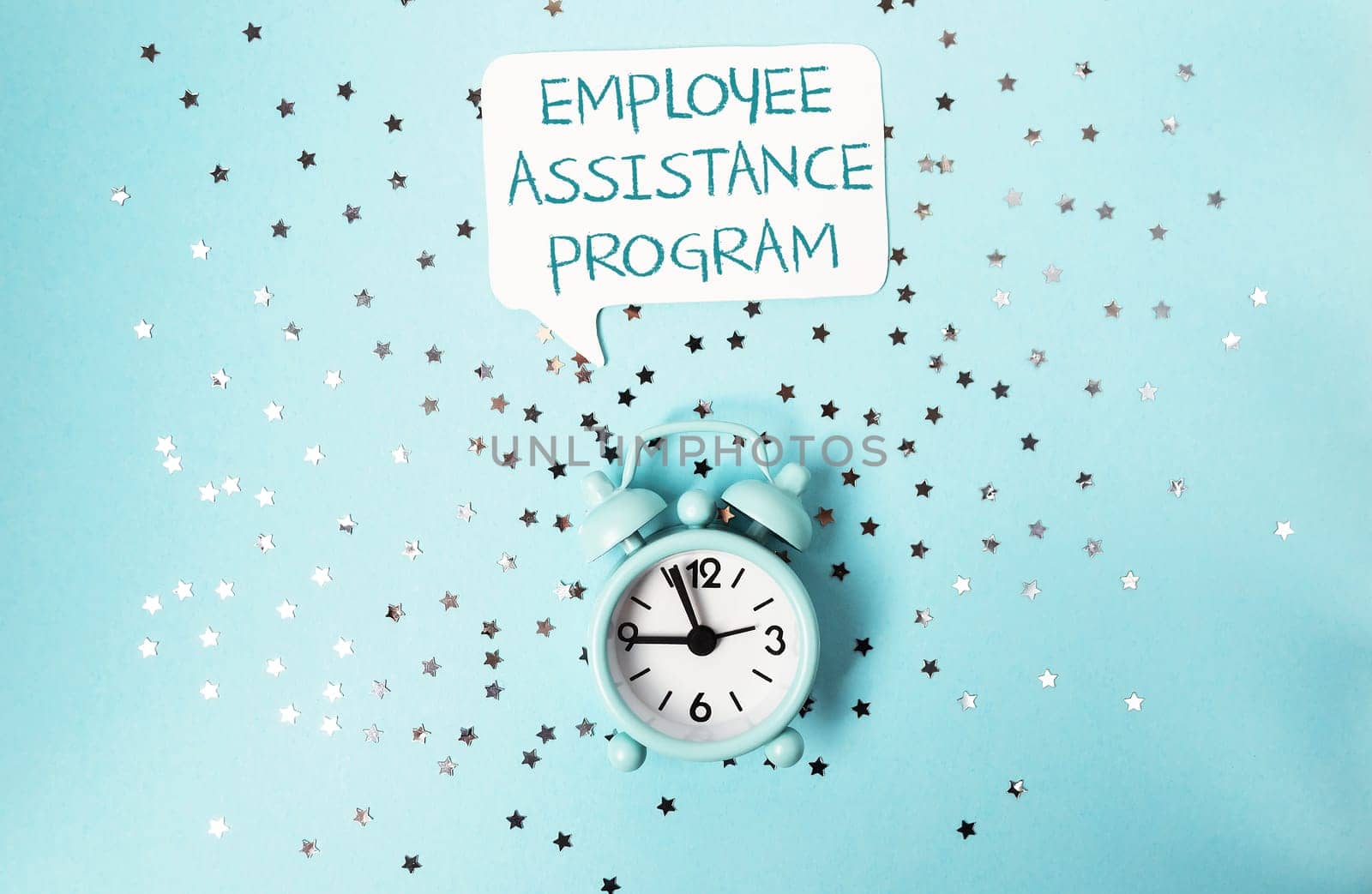 A clock with the words Employee Assistance Program written above it. The clock is on a blue background with a lot of stars