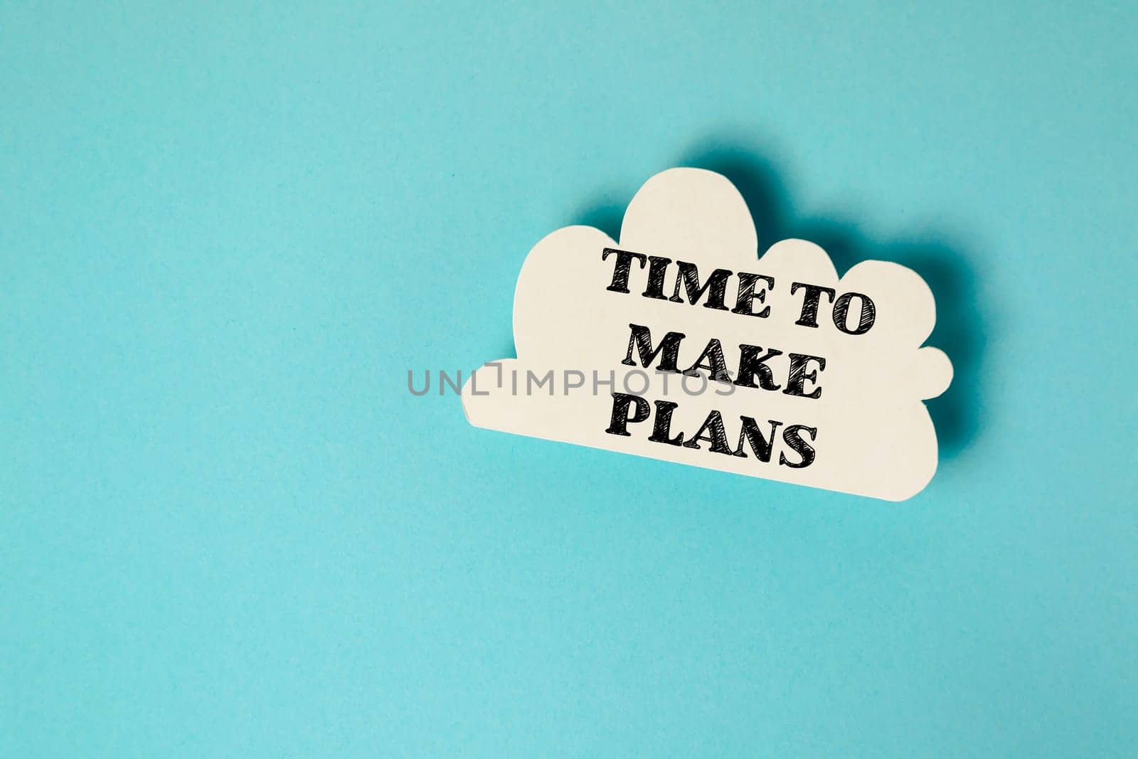 A cloud with the words "Time to make plans" written on it. Concept of urgency and the importance of taking action