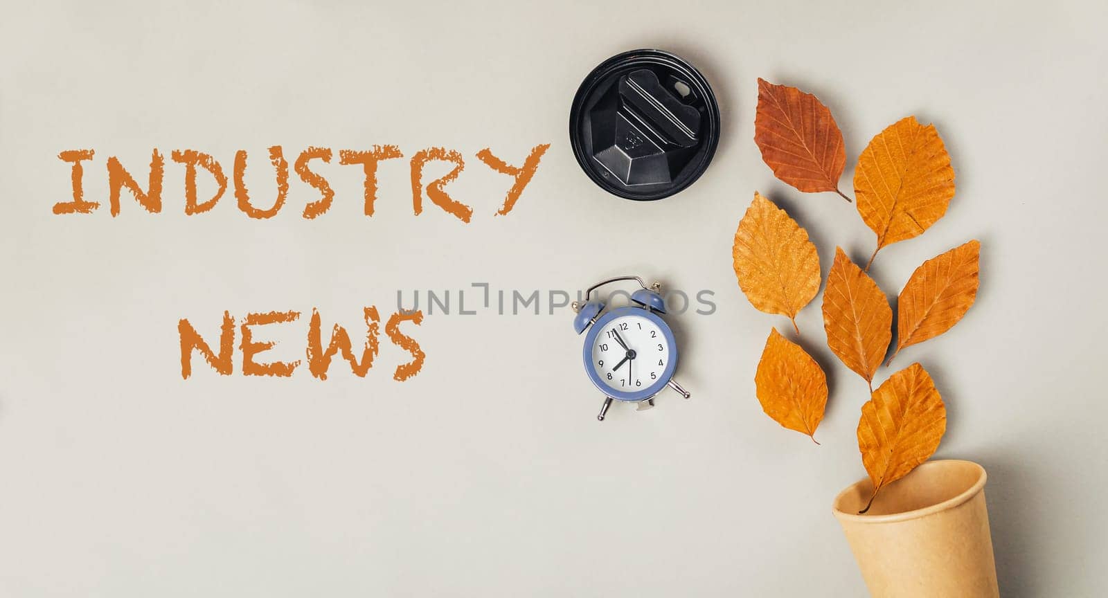 A clock and leaves are on a wall with the words Industry News written below. Concept of time passing and the importance of staying up to date with industry news