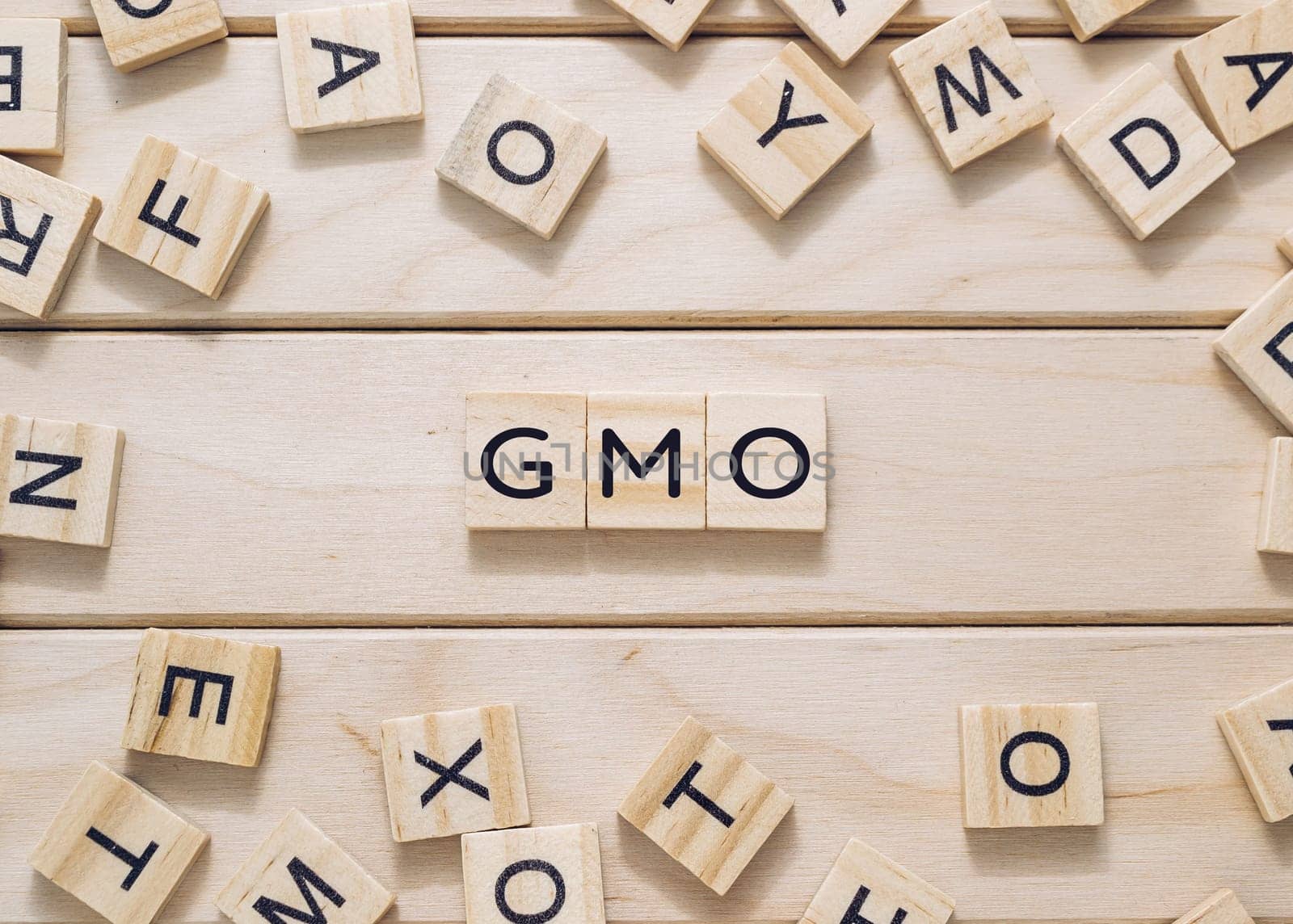 A jumble of wooden letters spell out GMO by Alla_Morozova93