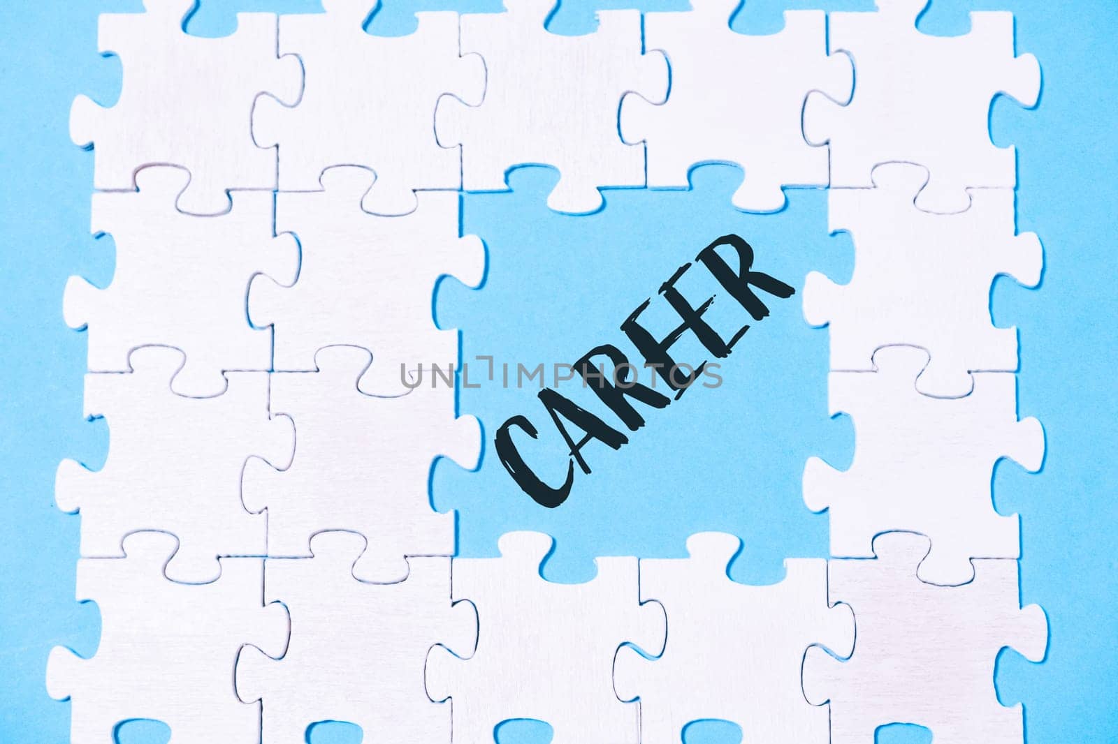A jigsaw puzzle with the word career written in blue. The puzzle is made up of white pieces and is scattered across the image