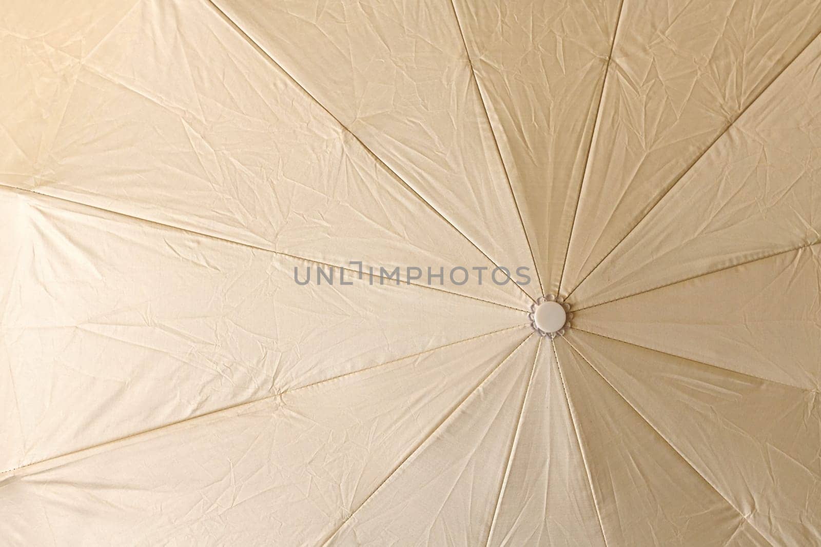 Background from an open beige umbrella by olgavolodina