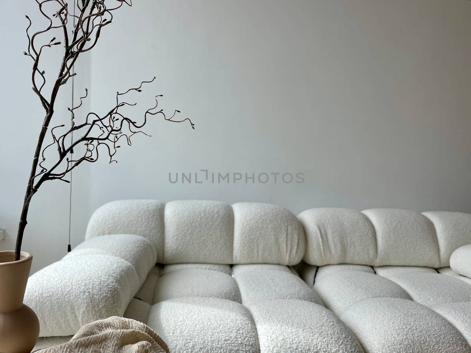 A light beige sofa as part of the decor of a modern interior. High quality photo