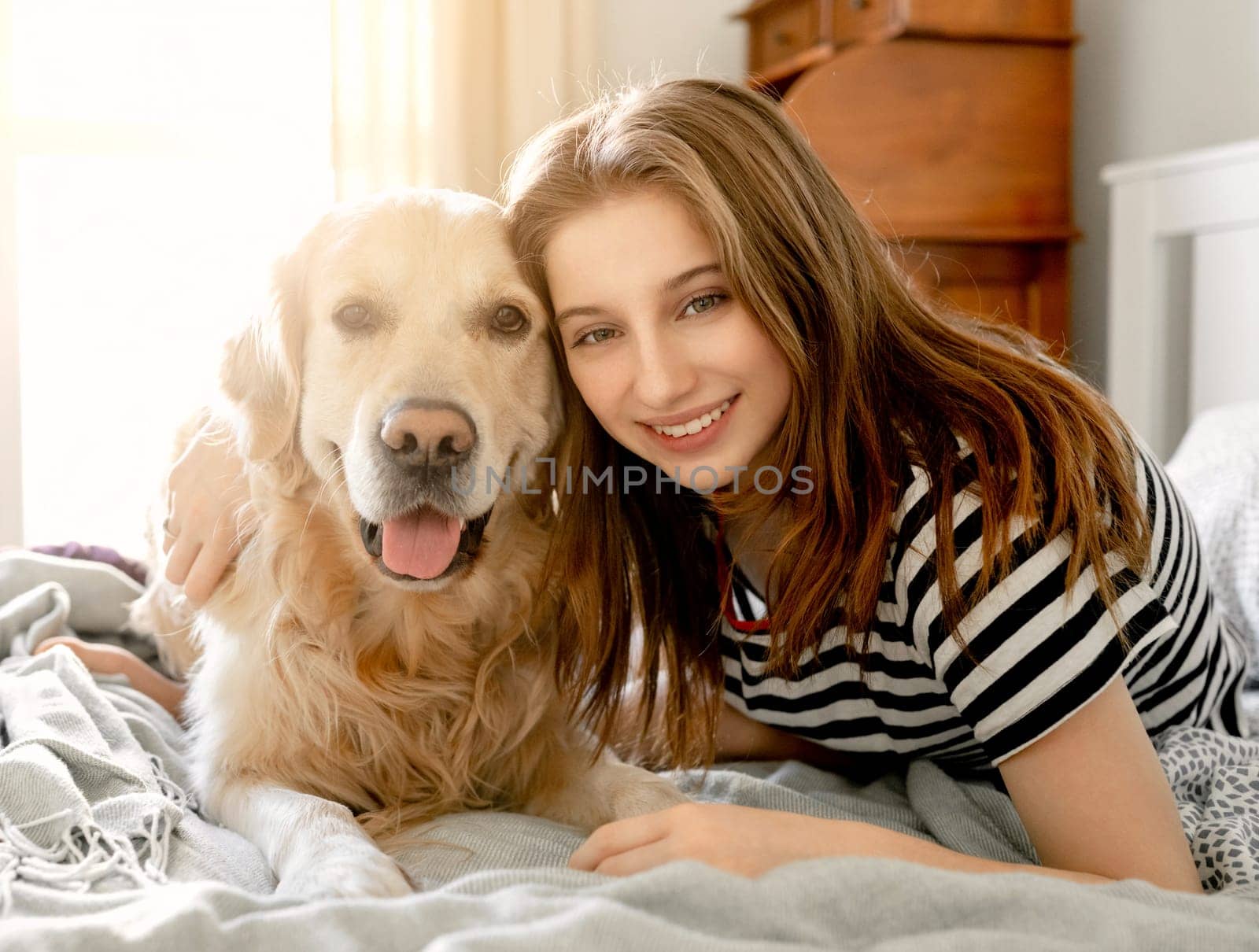 Girl with golden retriever dog in bed by tan4ikk1