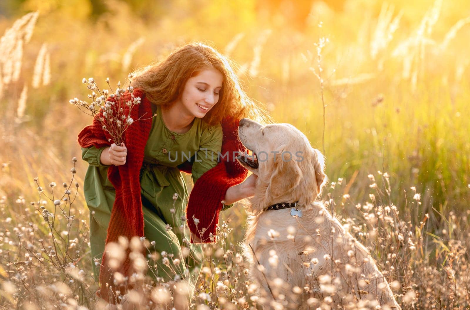 Young girl petting dog in nature by tan4ikk1