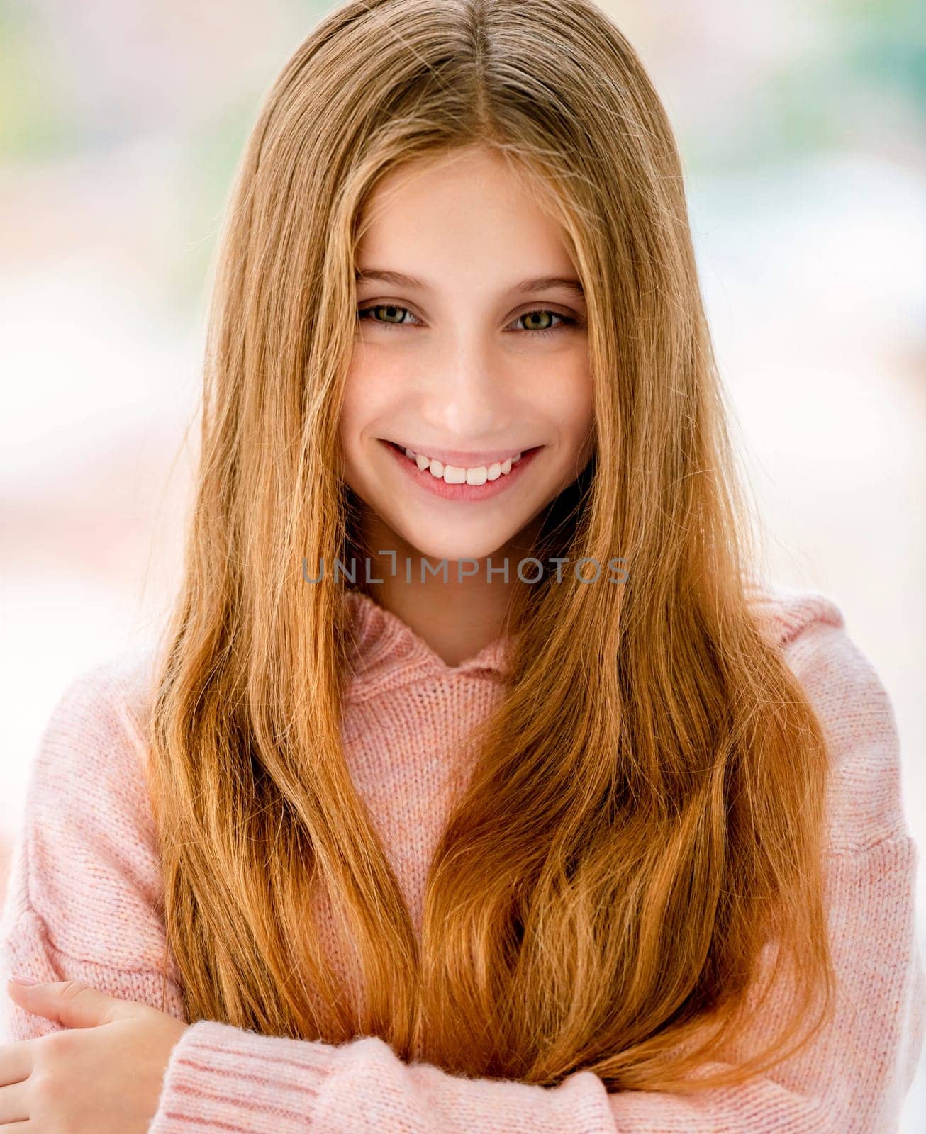 Cute long haired teenage girl smiling to camera