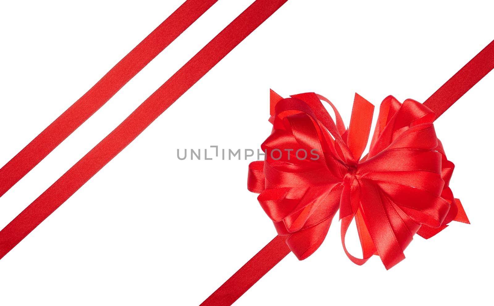 Tied bow made of red silk ribbon on an isolated background, decor for a gift by ndanko