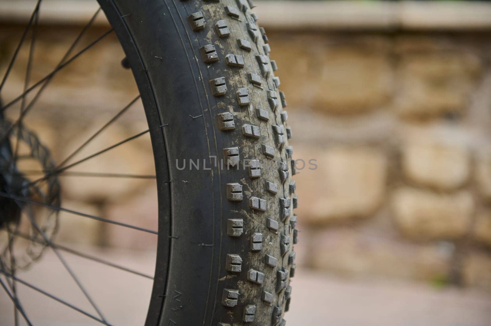 Details on tubeless tire of an electric motor bike, mountain bike. Shallow tread of a bicycle tubeless tire. Cropped view of electric bike bicycle wheel with spokes. Copy advertising space