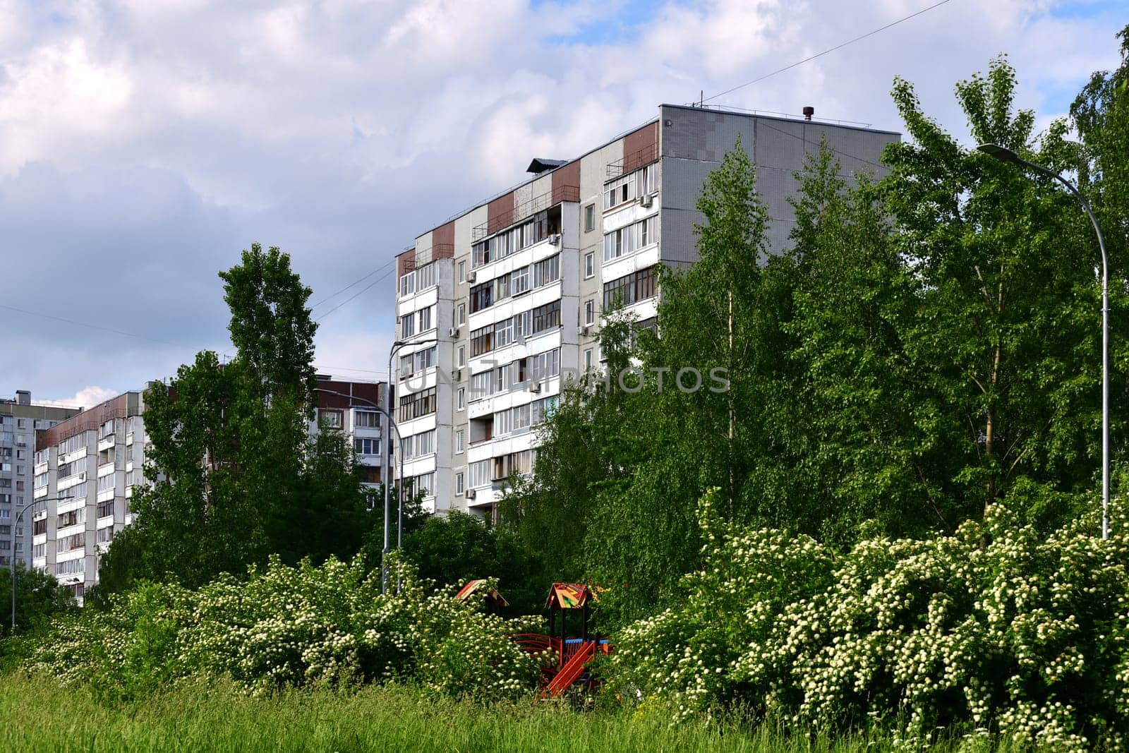 City houses surrounded by trees in Moscow, Russia by olgavolodina