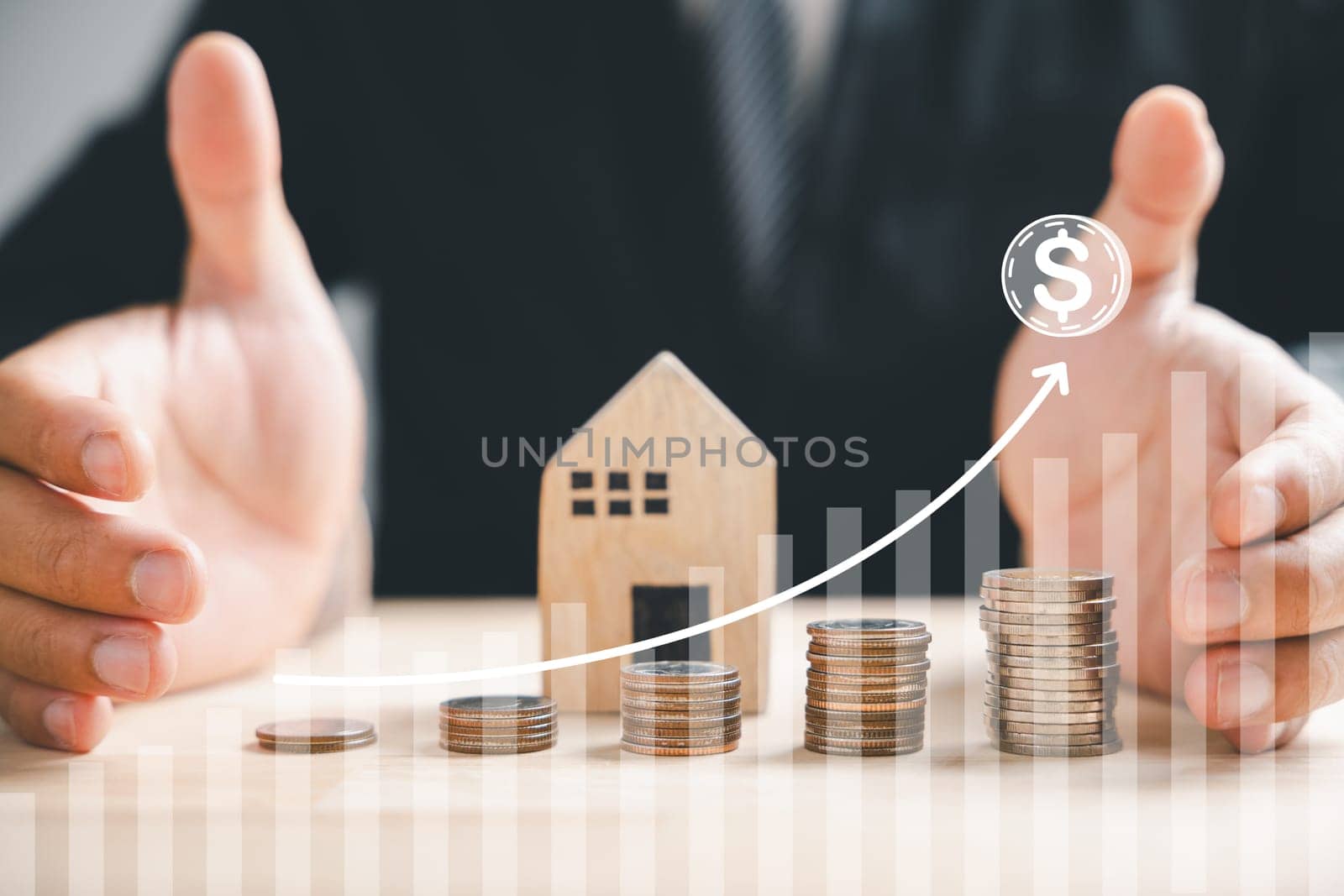 Businessman holds coin stack, house wood symbolizing real estate profit. Investment growth, passive income strategy. Future budgeting, market concept, and asset building. arrow graph
