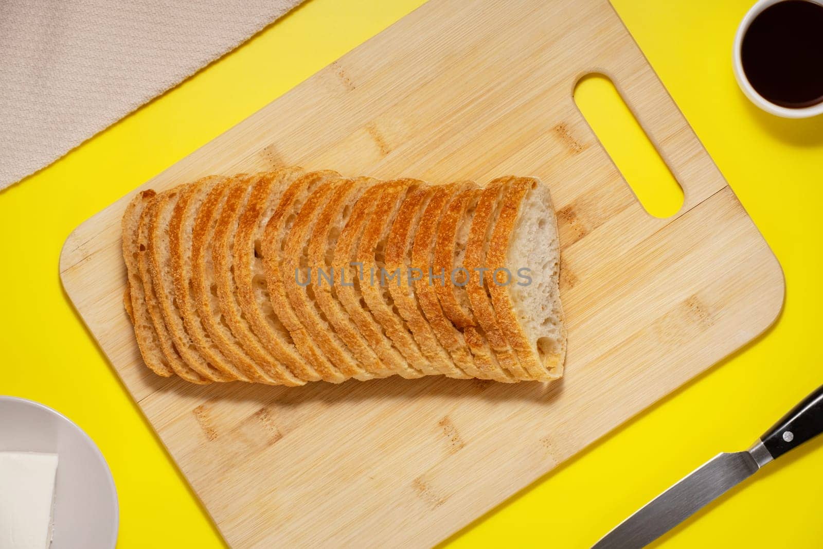 Ciabatta bread sliced on a board, top view by NataliPopova