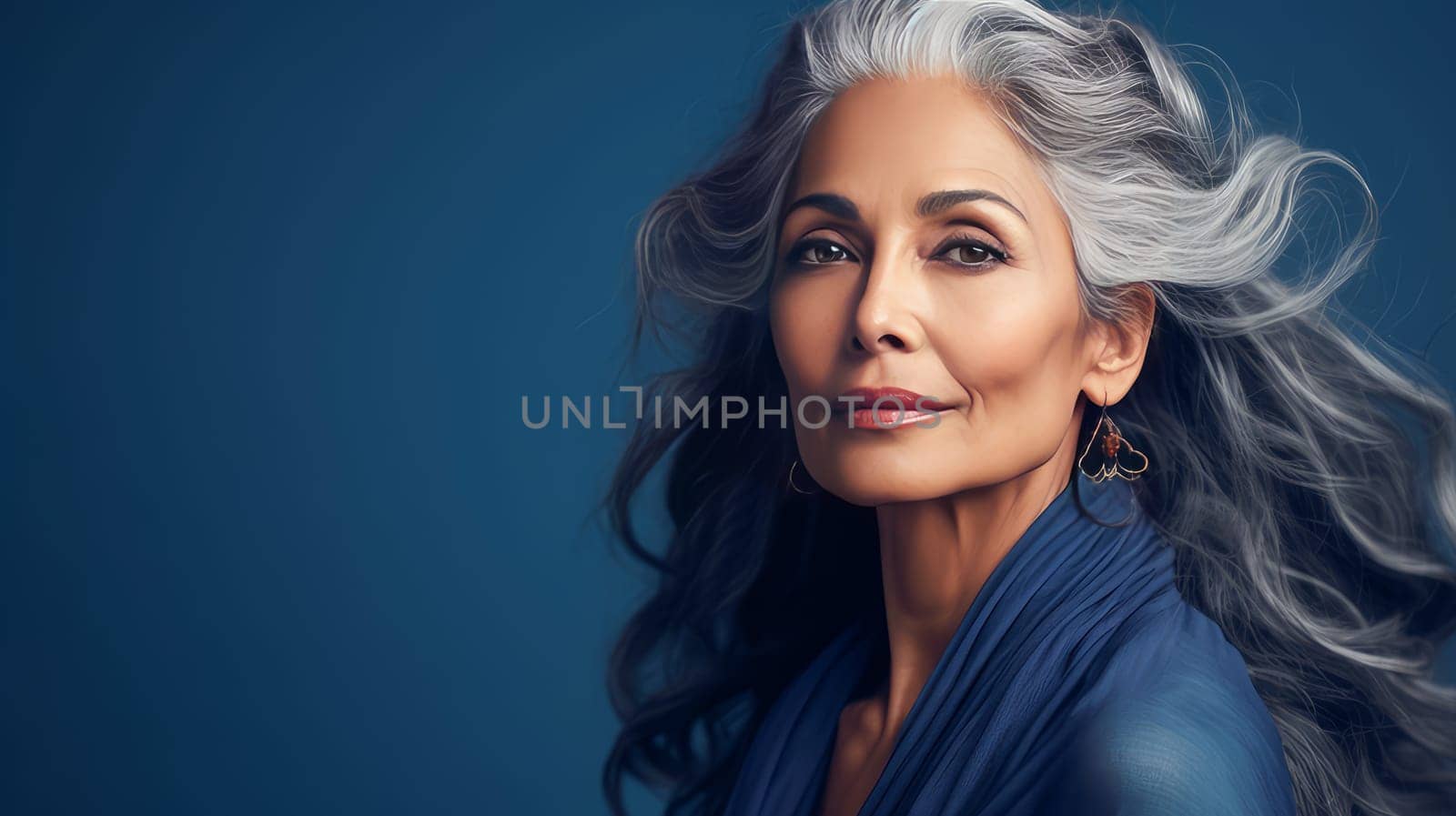 Elegant, elderly, chic latino, Spain woman with gray long hair and perfect skin, blue background, banner. Advertising of cosmetic products, spa treatments, shampoos and hair care products, dentistry and medicine, perfumes and cosmetology for women