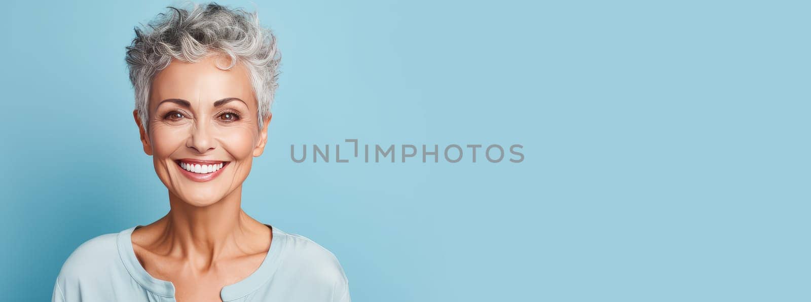 Elegant, smiling elderly, chic latino, Spain woman with gray hair and perfect skin, blue background banner. Advertising of cosmetic products, spa treatments, shampoos and hair care products, dentistry and medicine, perfumes and cosmetology for women