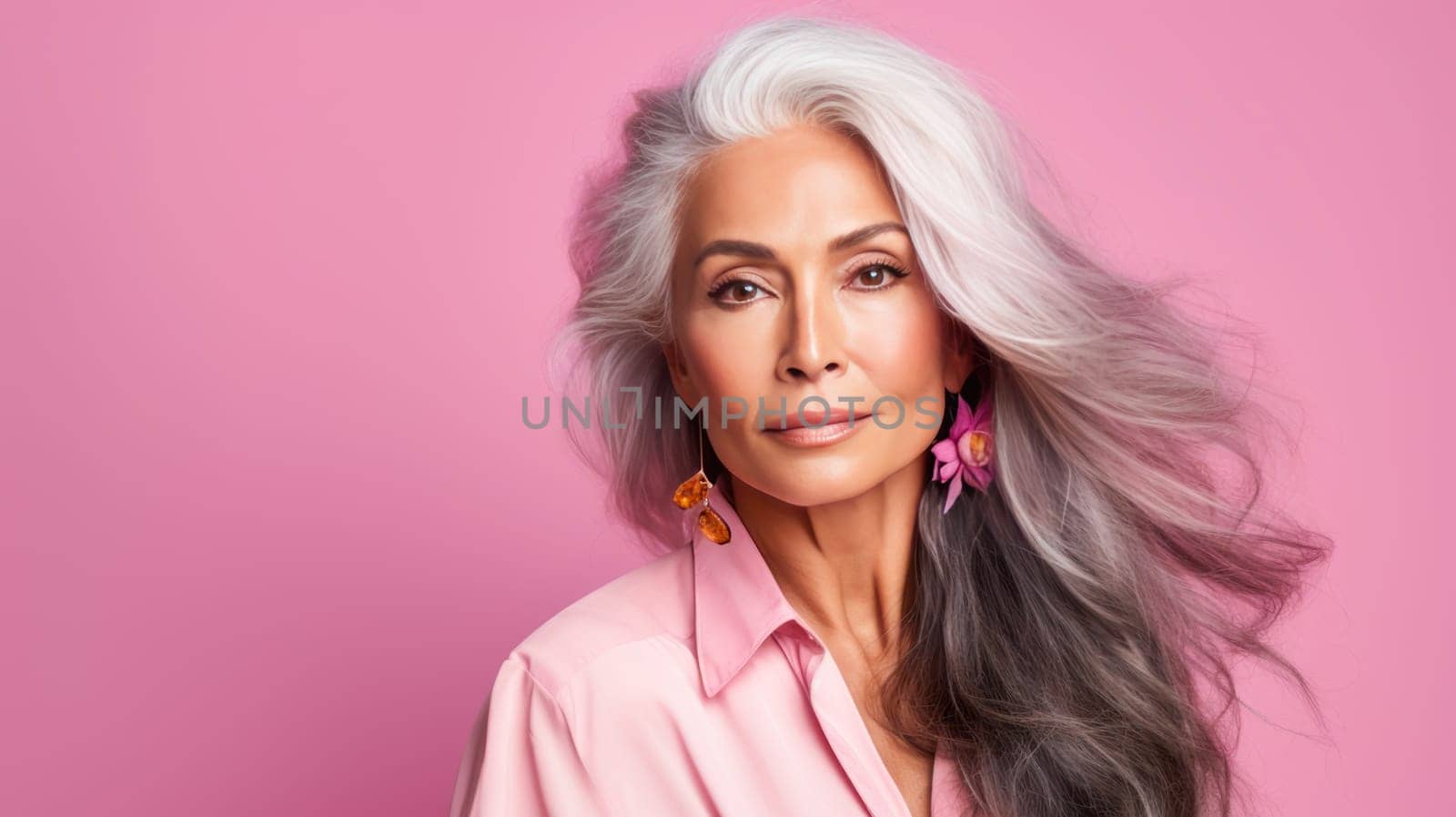 Elegant, elderly, chic Latino, Spain woman with gray long hair and perfect skin, pink background, banner. Advertising of cosmetic products, spa treatments, shampoos and hair care products, dentistry and medicine, perfumes and cosmetology for women