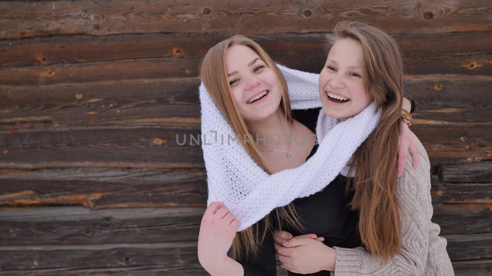 Young friends posing in the village in winter