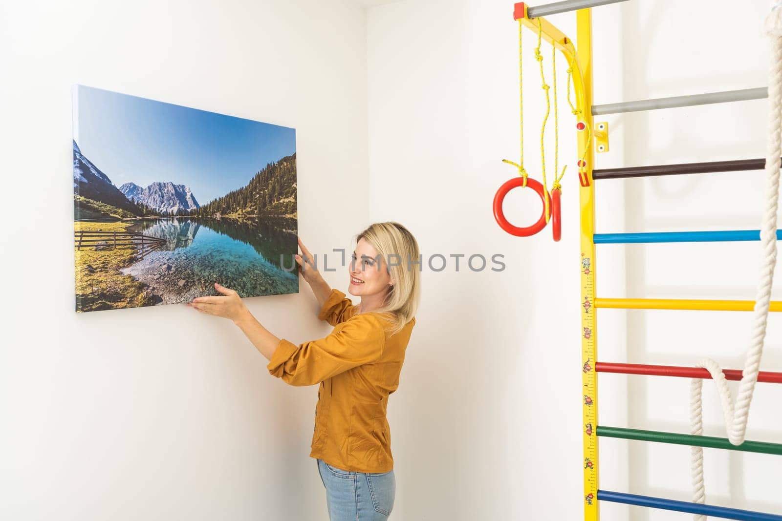 Young woman in yellow blouse hold canvas. Minimal art concept