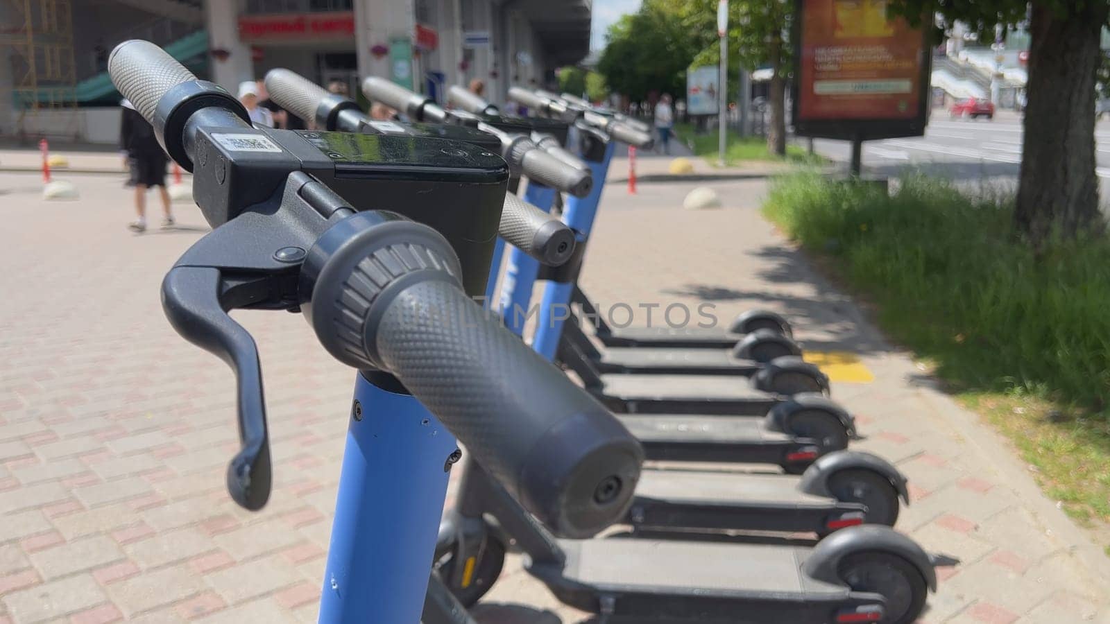 Electric scooters are on the street waiting to be rented. by DovidPro