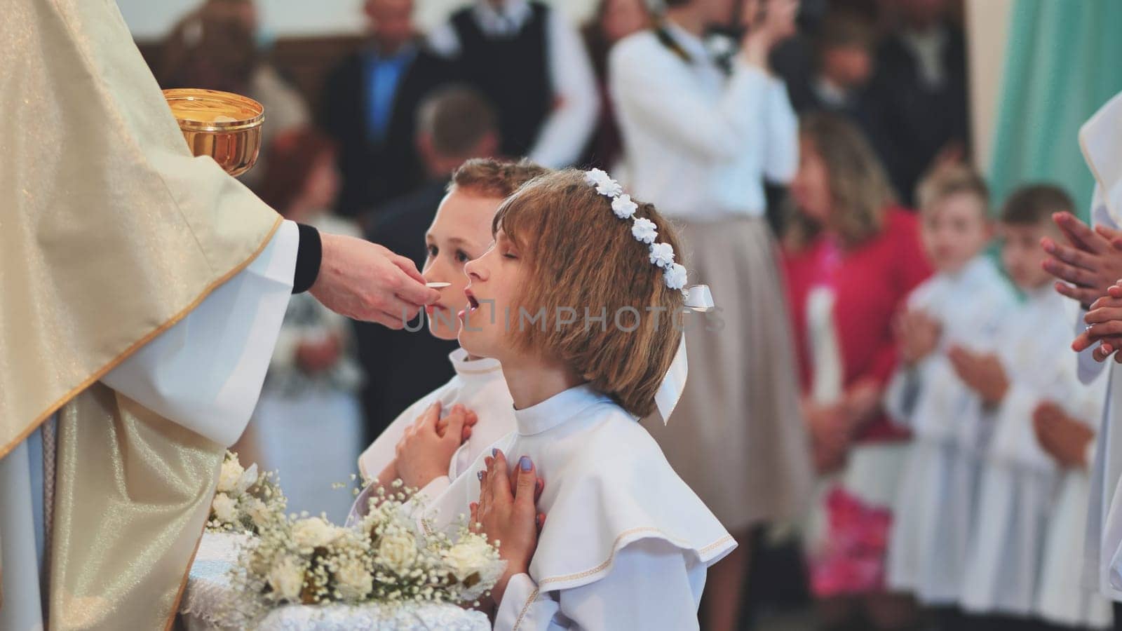 Lida, Belarus - May 31, 2022: Children going to the first holy communion. by DovidPro