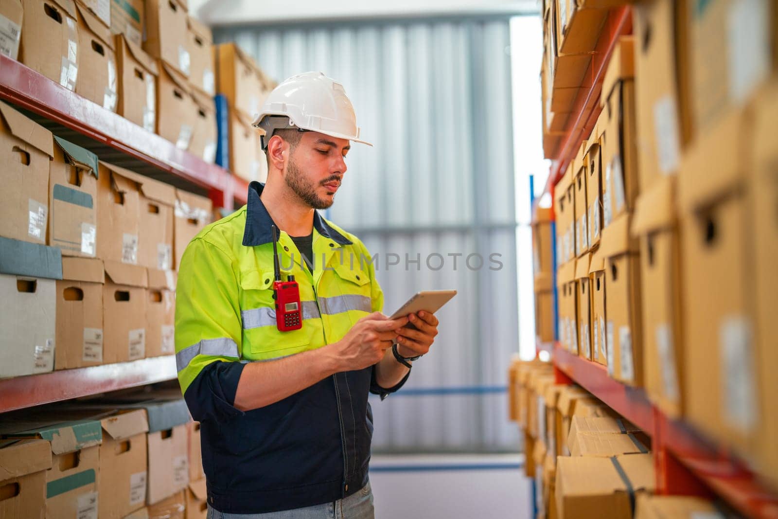 Professional warehouse worker hold tablet and check the product on shelves in workplace. The concept of good system support the worker for stock and shipment factory industry. by nrradmin