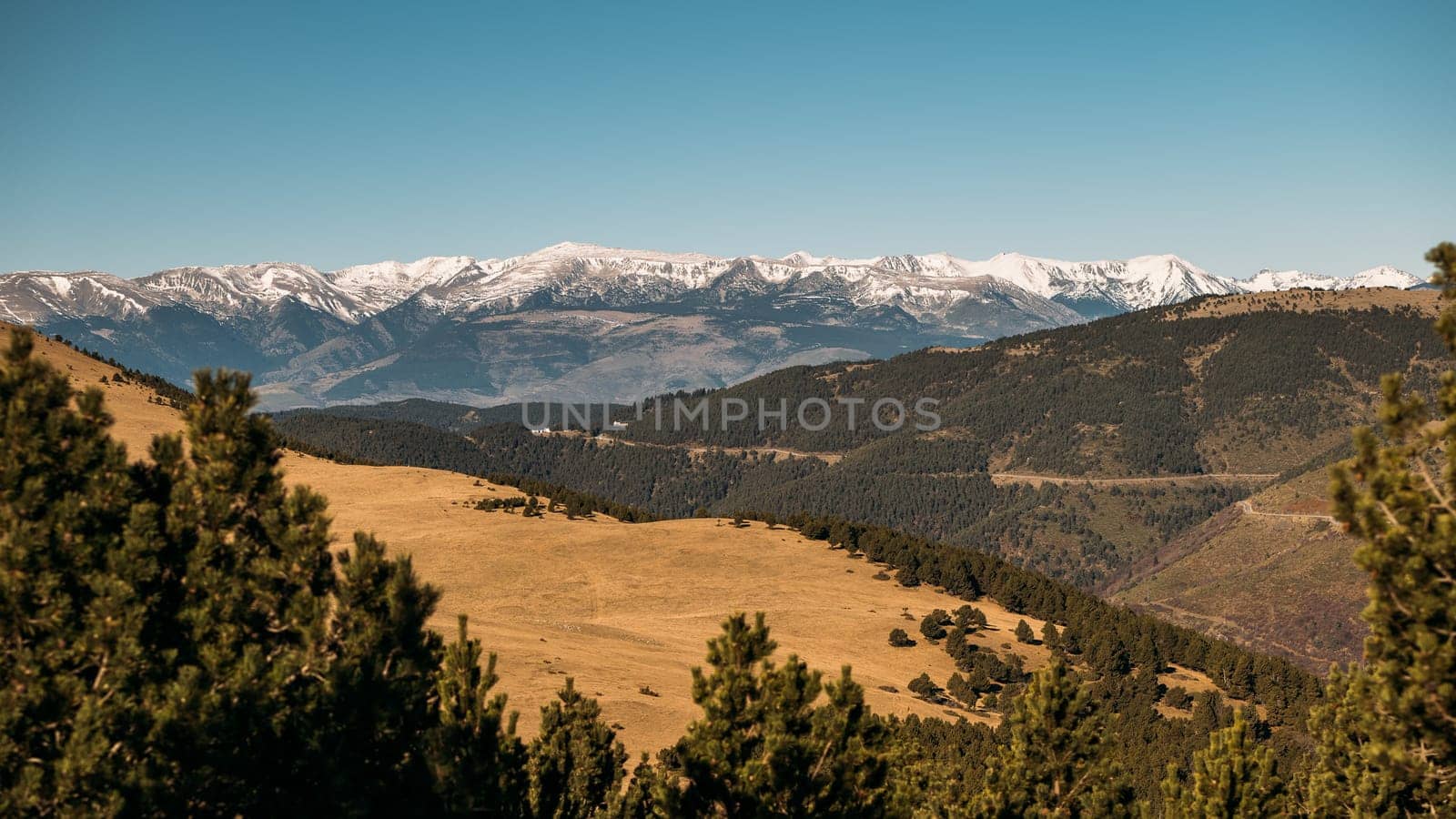 Snow-Capped Mountains Dominating the Horizon under a Clear Sky by apavlin