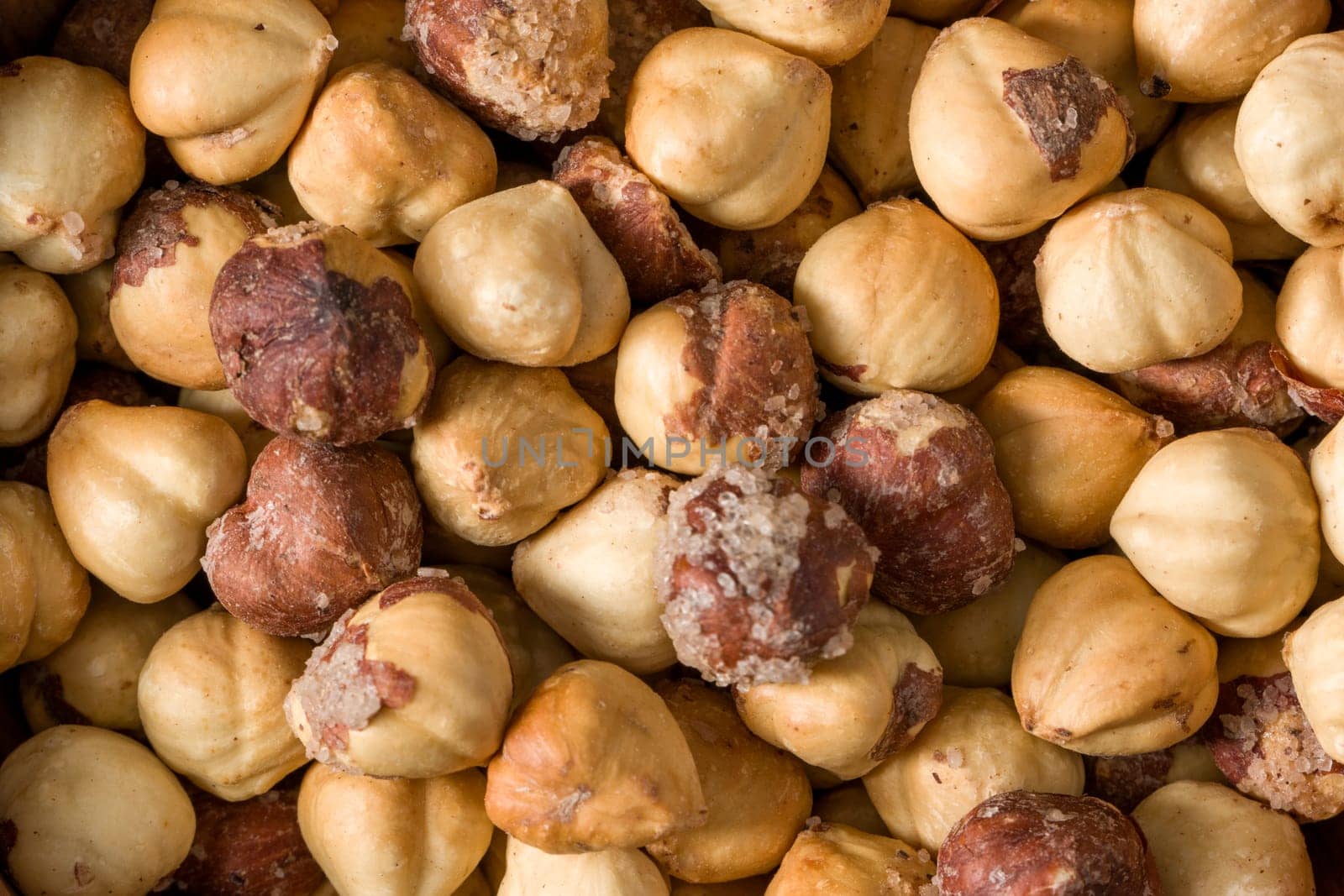 close-up view of roasted salted hazelnuts from above by Sonat