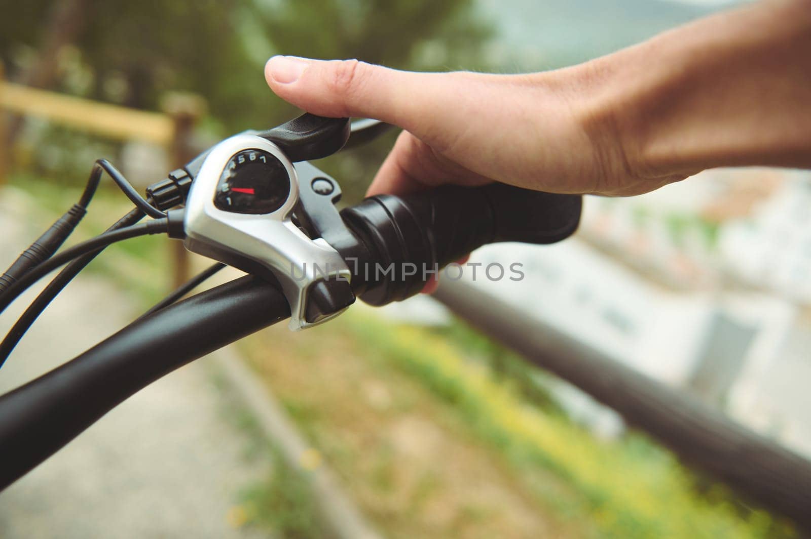 Isolated bicycle brakes in male cyclist's hand. Adjusting bicycle hand brakes while riding cycling on the nature. Close-up view by artgf