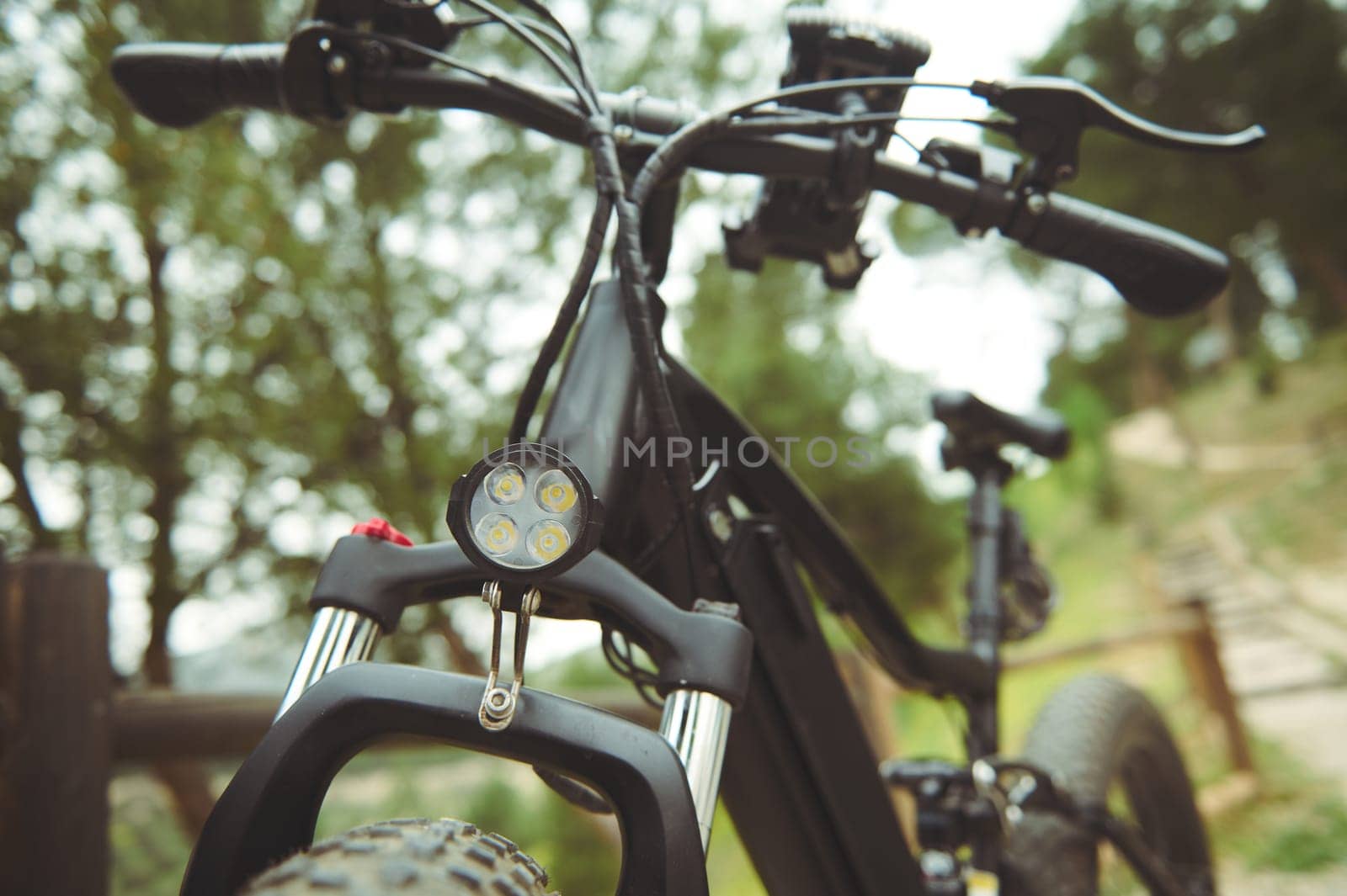 Cropped view of a modern ecologically friendly mode of transport - electric bike bicycle, motor bike on the nature. Bike sharing city service. Environmental conservation. Sustainable lifestyle by artgf