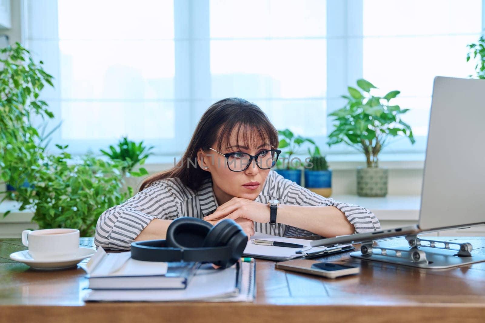 Sad upset business woman looking at computer screen by VH-studio