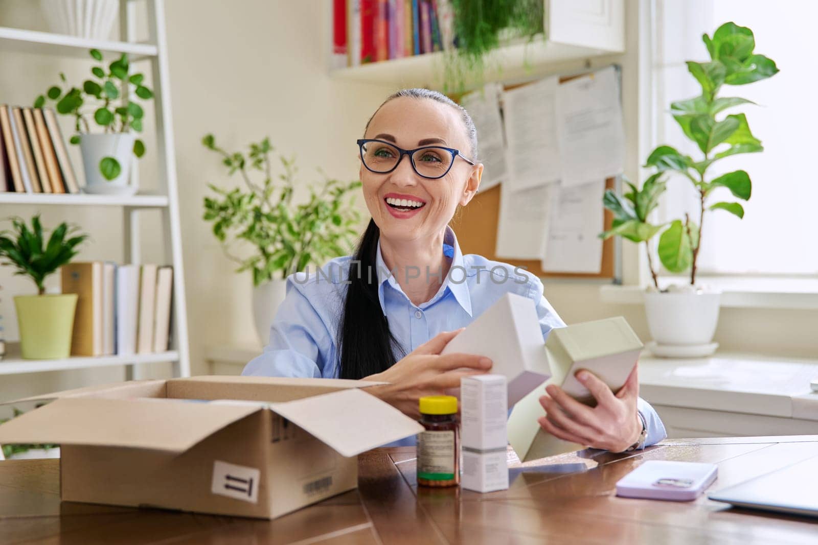 Female customer sitting at home unpacking cardboard box with online purchases by VH-studio