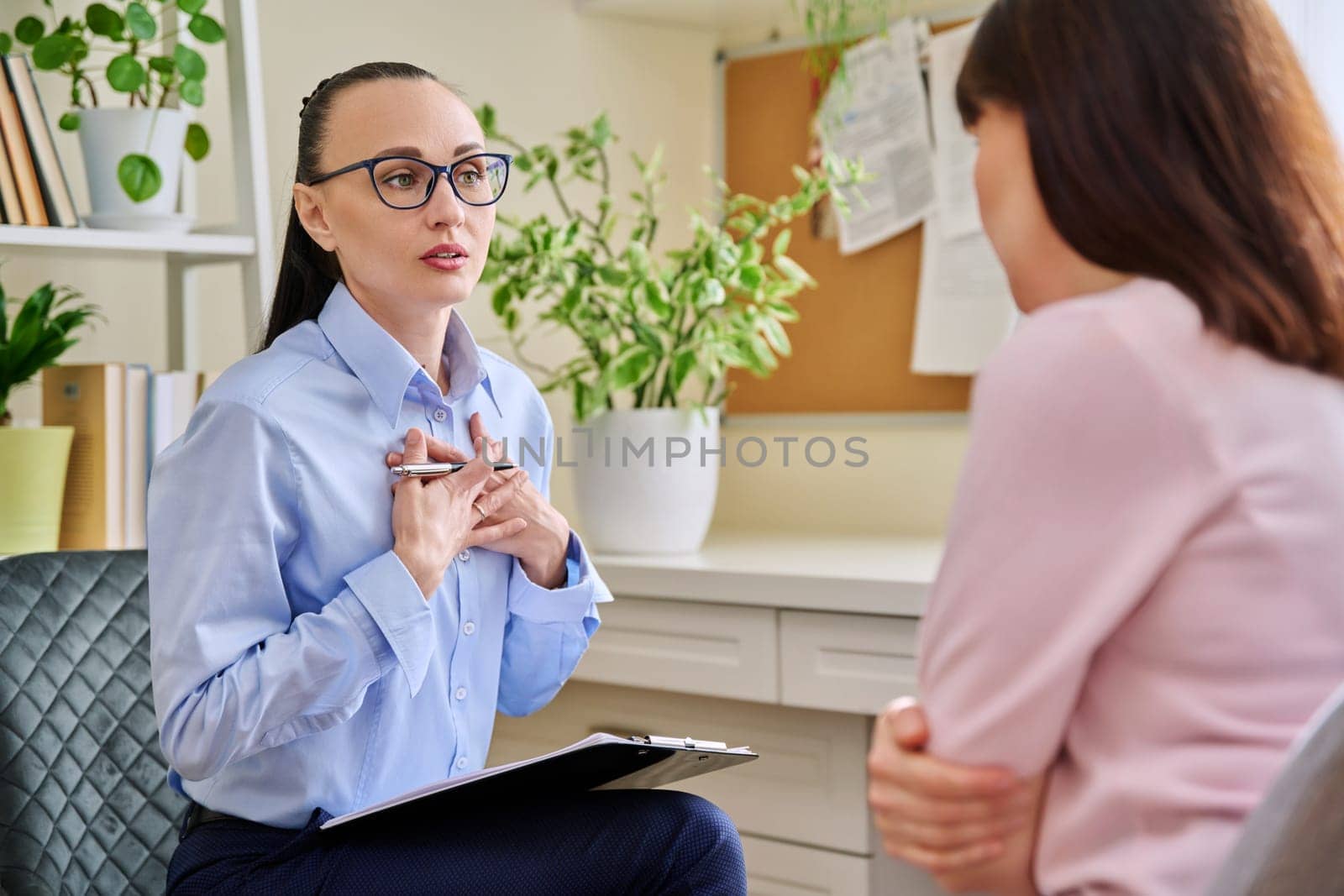 Professional mental psychologist counselor at therapy session with female patient. Talking women sitting in office, psychology, psychotherapy, counseling, health care, support help treatment concept