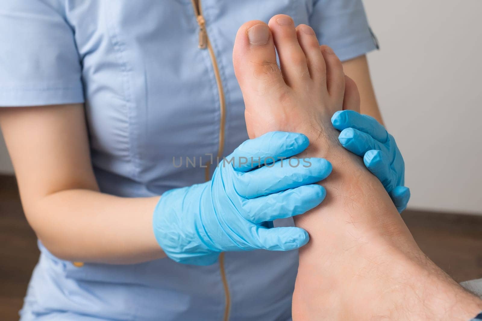 Professional masseur administers a foot massage to a man