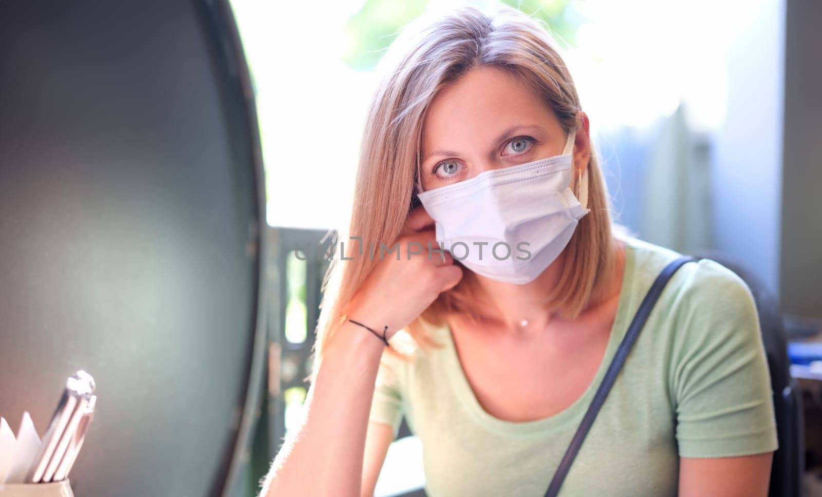 Portrait of young beautiful woman in protective mask on street by kuprevich