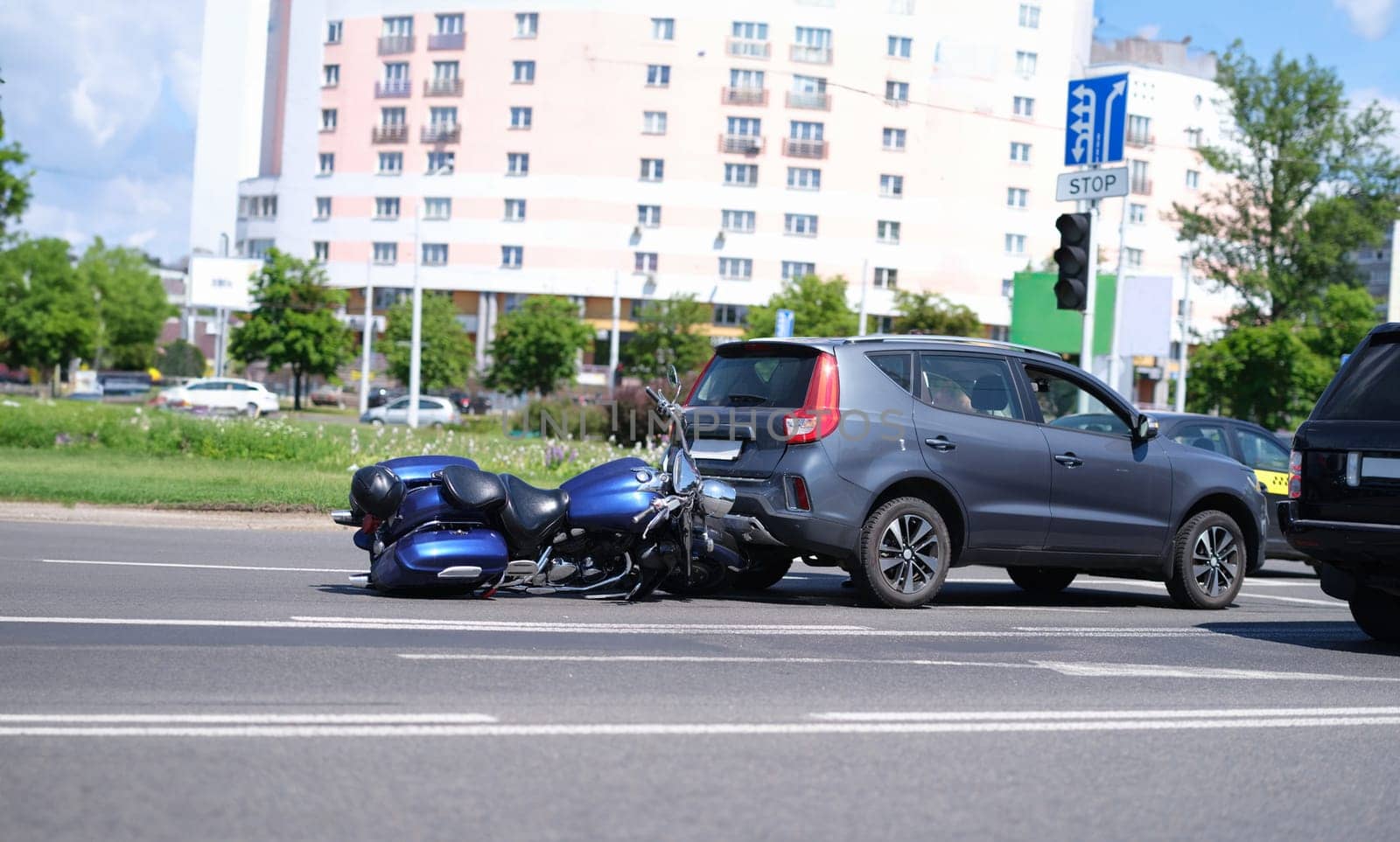 Motorcycle crashed into back of car on road closeup by kuprevich