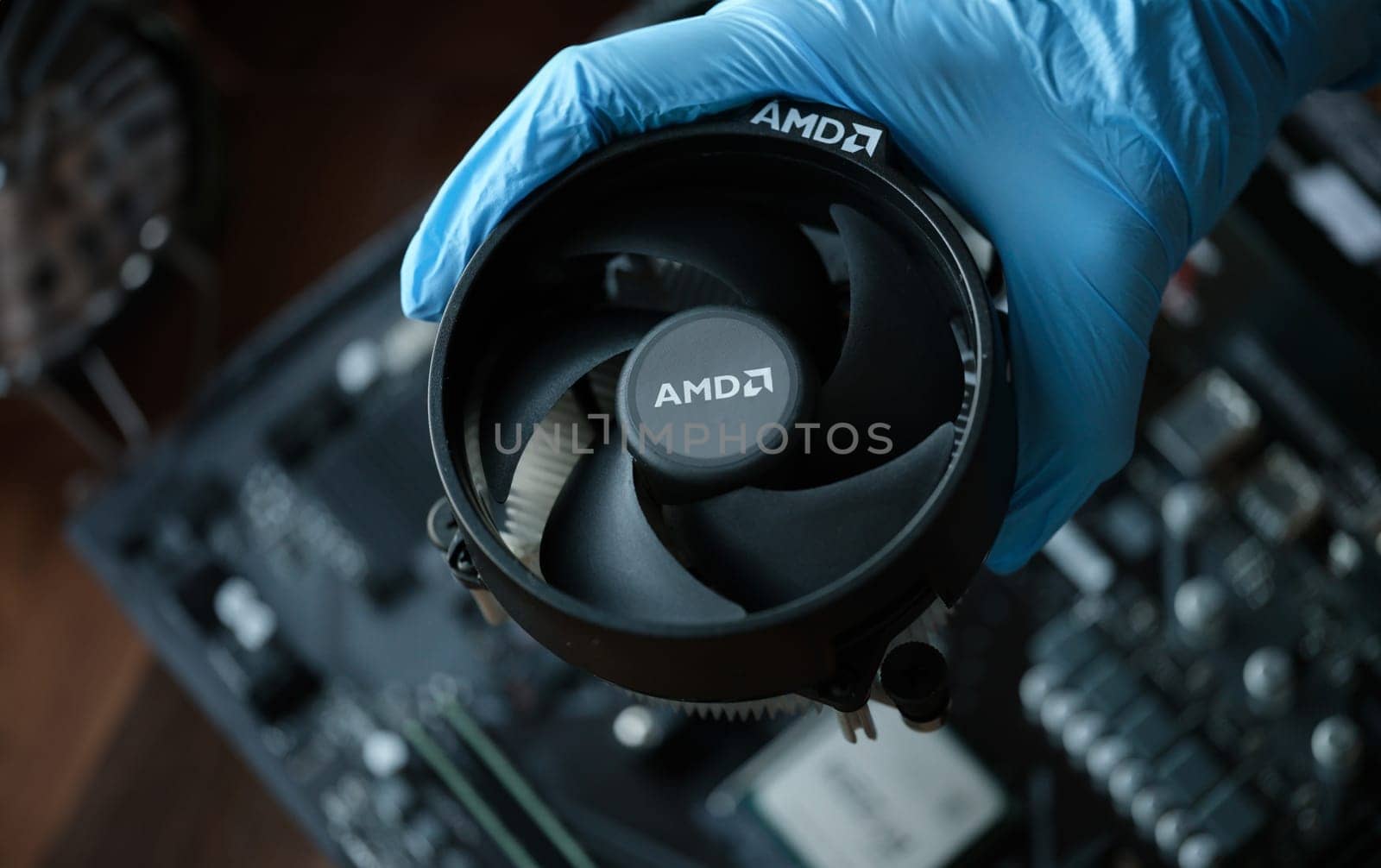 Hand in glove installs cpu fan AMD closeup by kuprevich