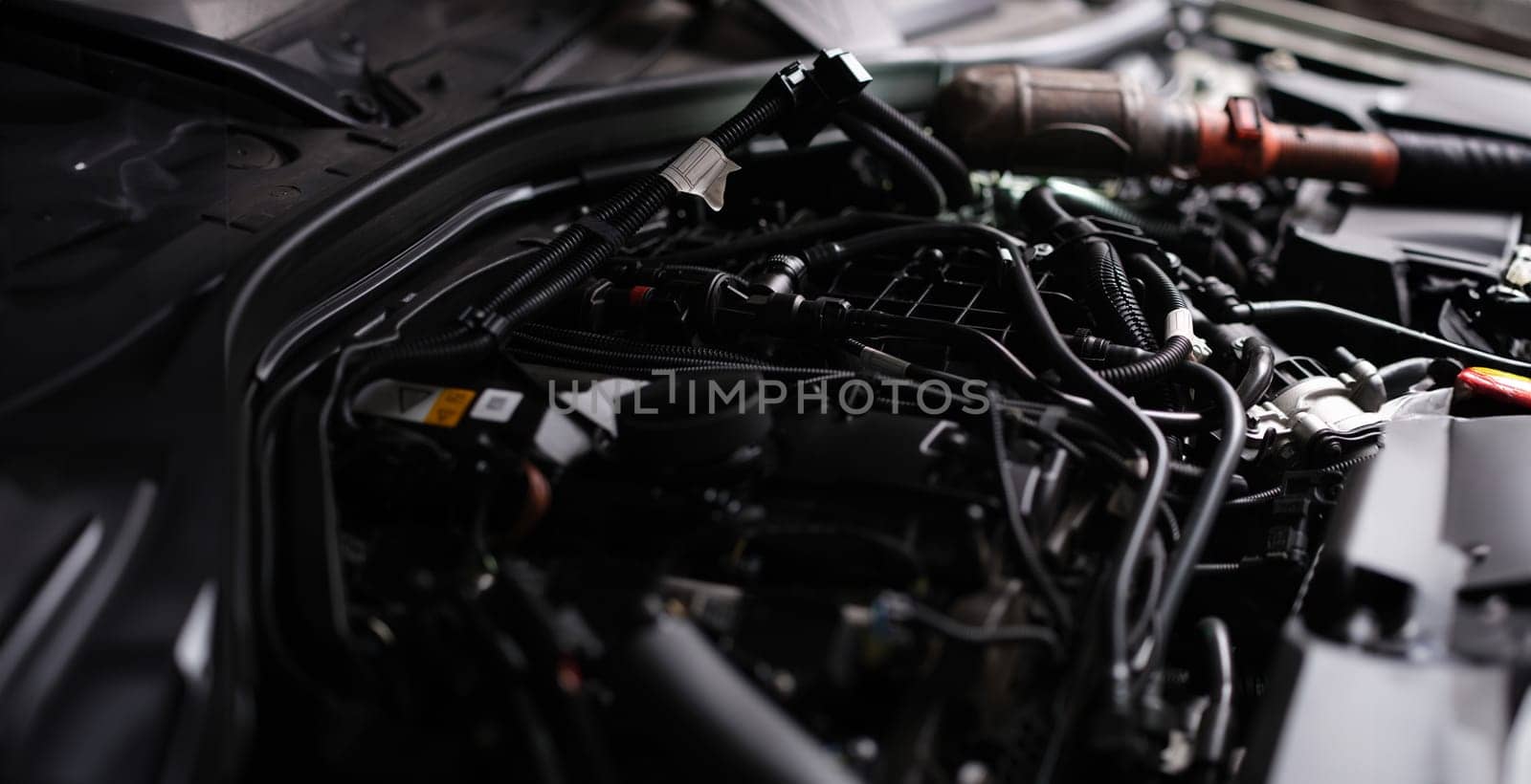 Closeup of electronics under hood of car. Car repair services concept