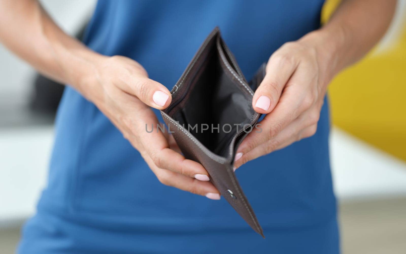 Business woman holding empty open wallet in hands closeup by kuprevich