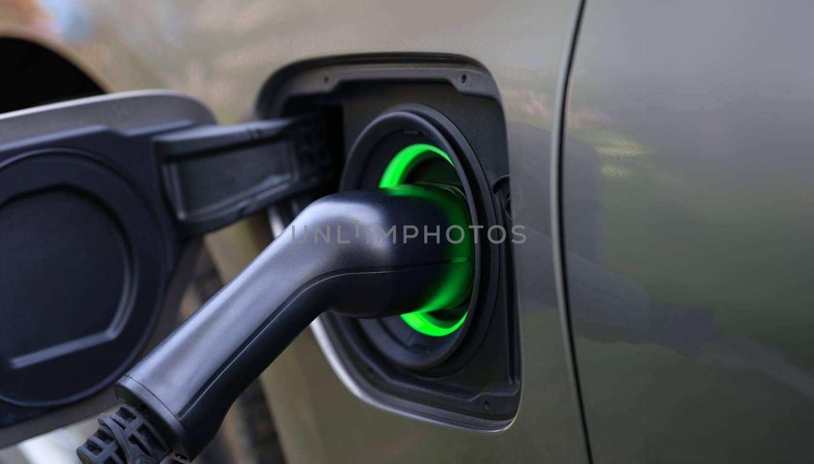 Electric car and charging at charging station closeup by kuprevich