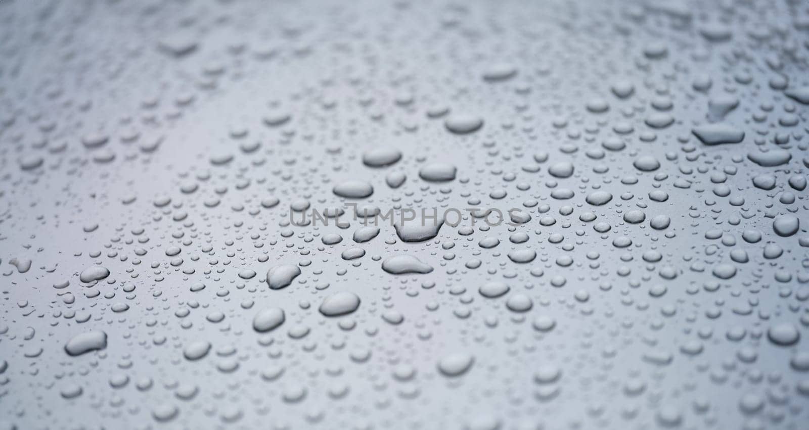 Raindrops on glass car for texture and background. Dark sky and rain on glass concept