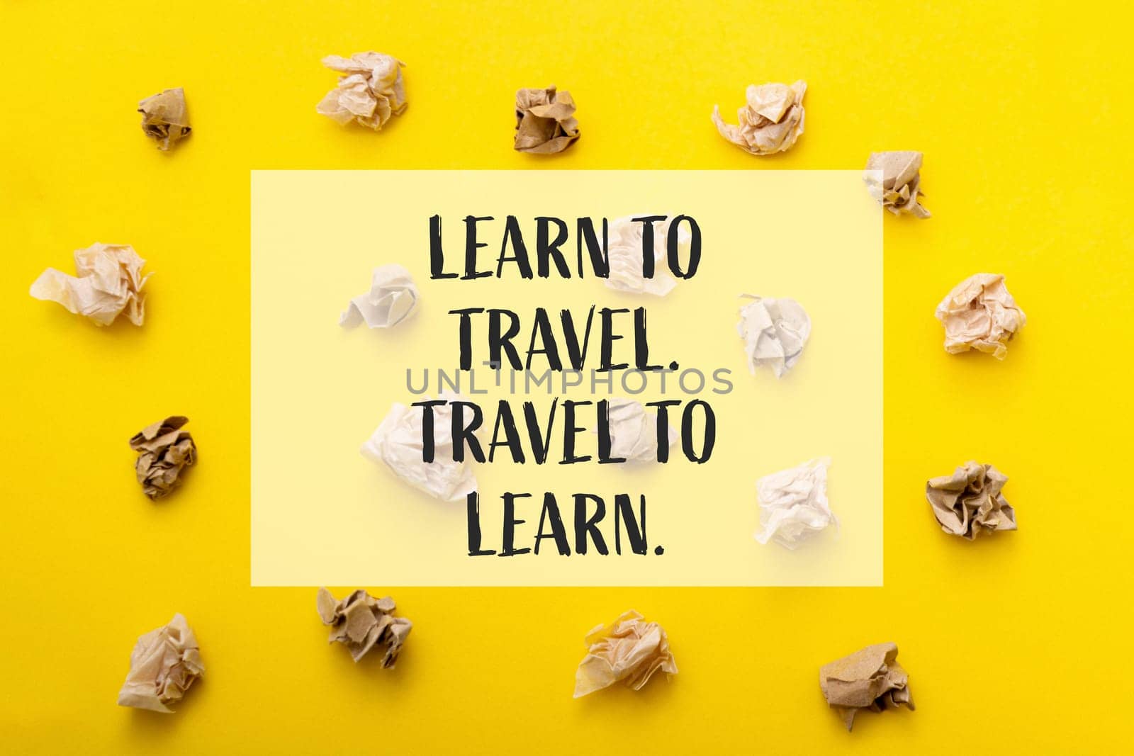 A yellow background with a bunch of crumpled paper on it. The words Learn to Travel, Travel to Learn are written in white on the background