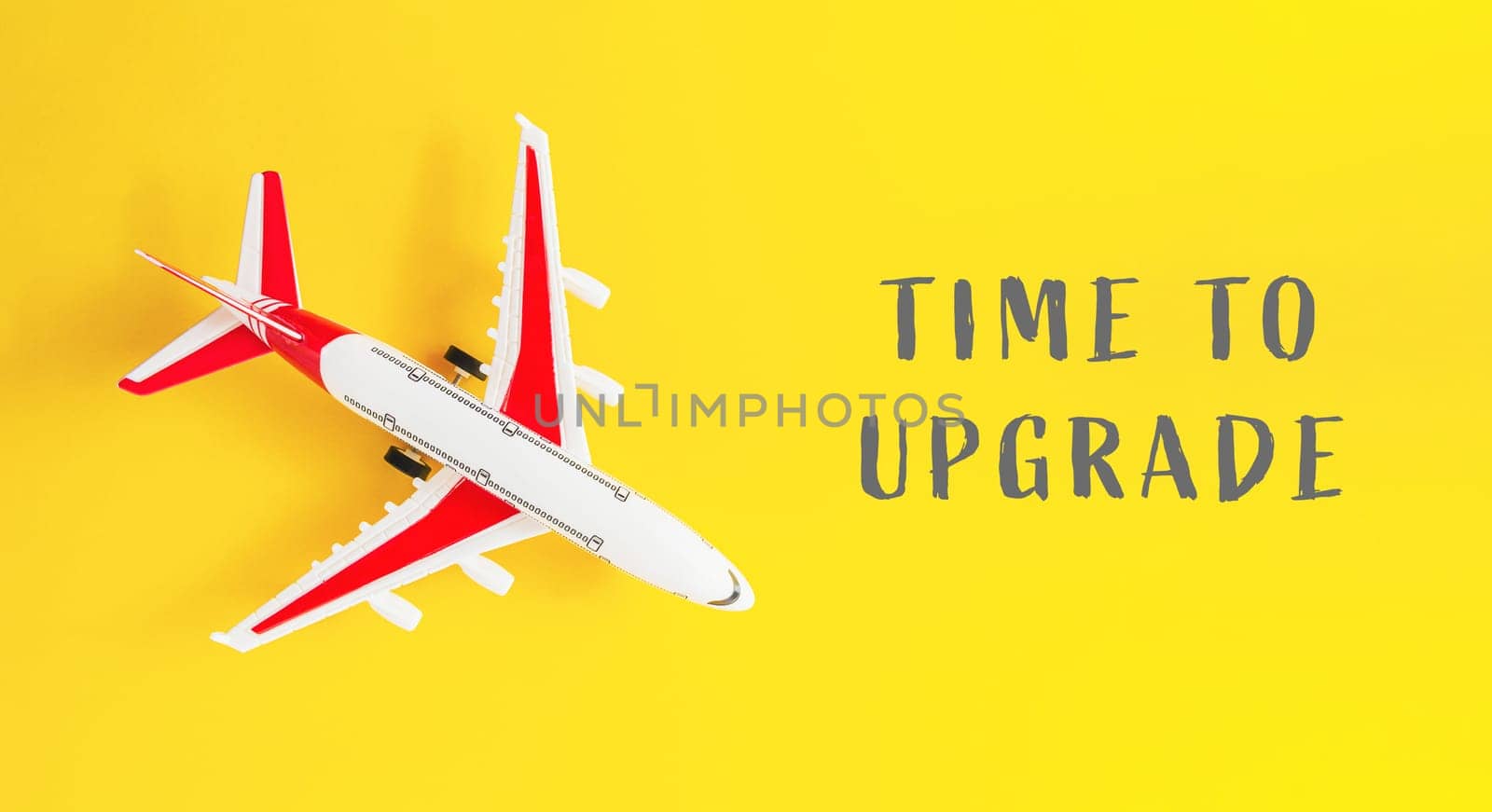 A small airplane is on a yellow background with the words Time to Upgrade written below it
