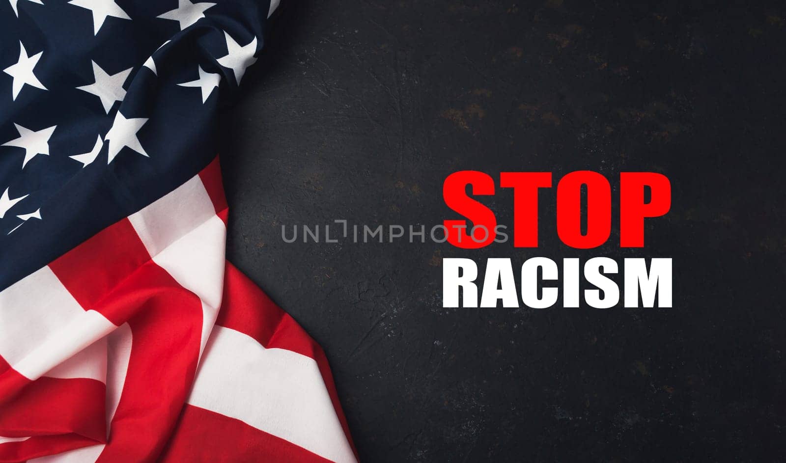 A red and white American flag with the words Stop Racism written underneath it. The flag is on a black background
