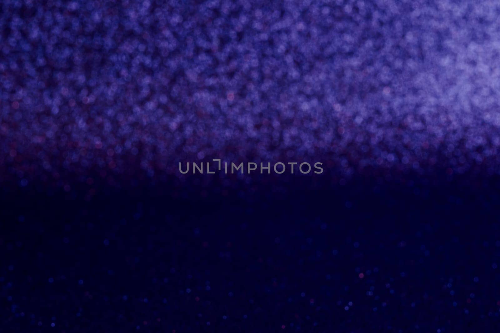 A blurry image of a blue background with purple and red dots. The image has a dreamy, ethereal quality to it