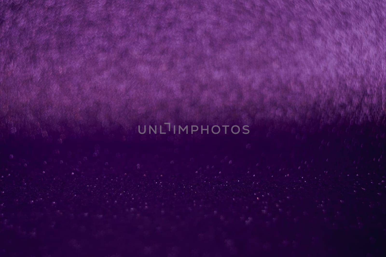 A purple backdrop featuring a blurred purple line, adding a touch of elegance and intrigue to the overall composition.