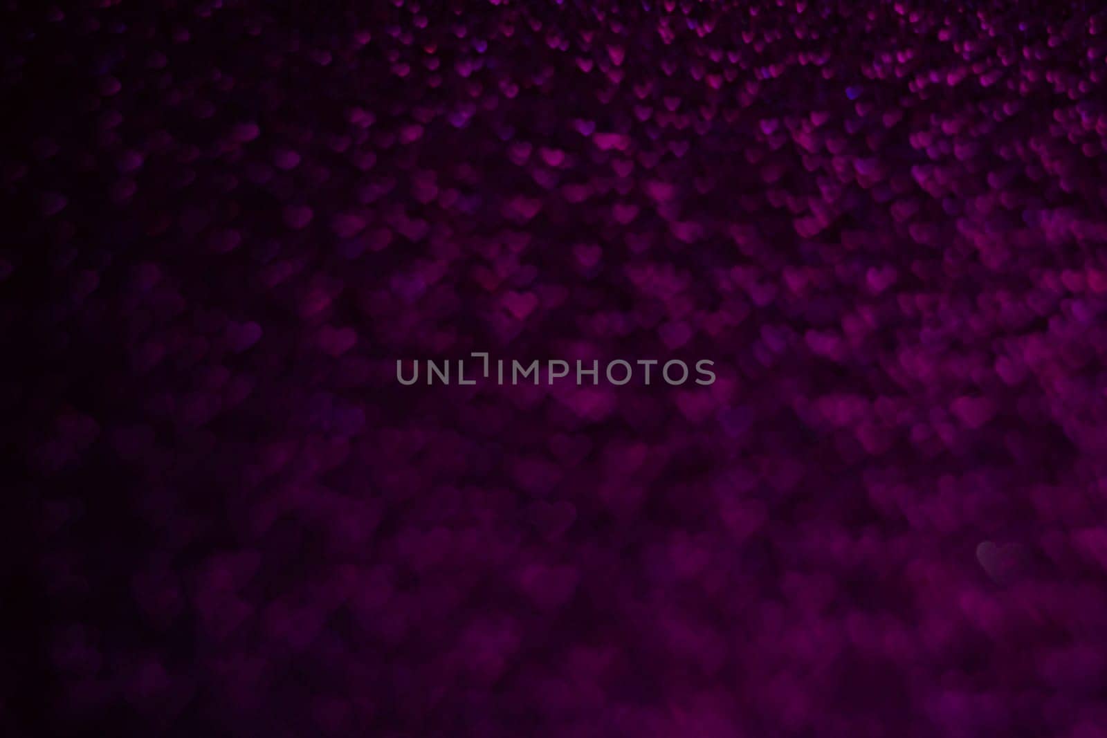A purple background with many small hearts scattered throughout. The image has a romantic and dreamy feel to it