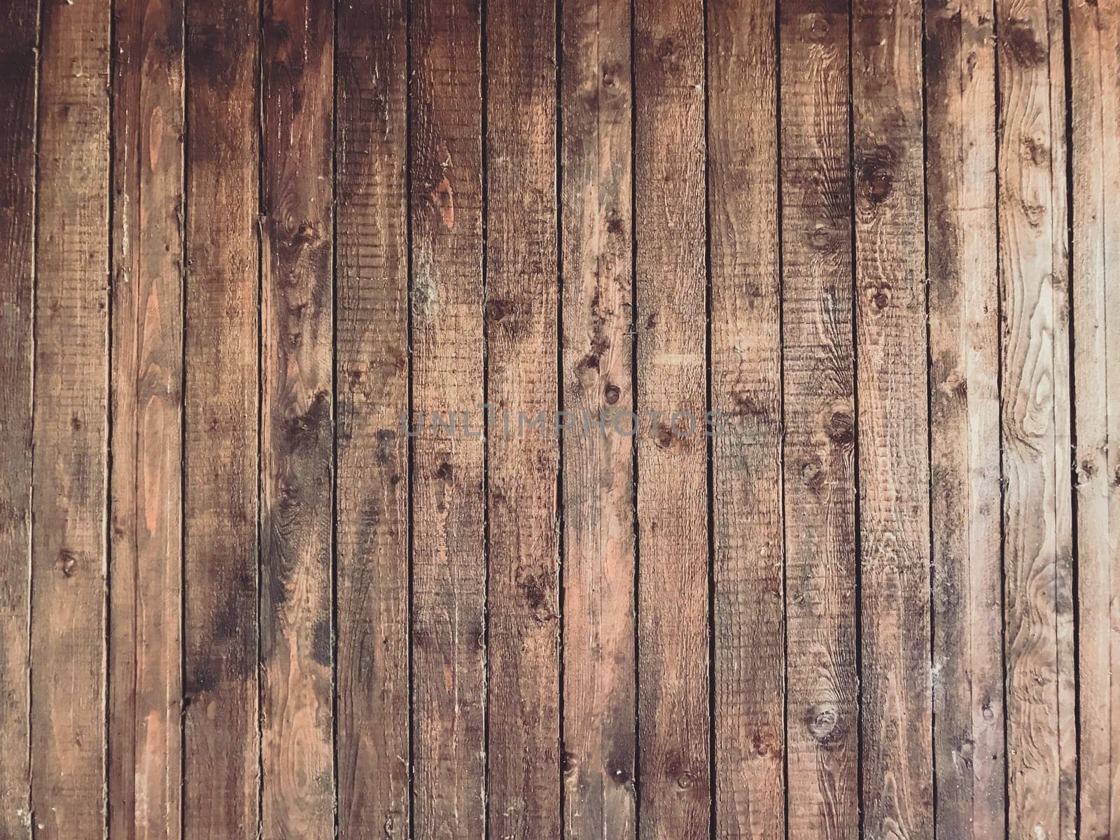 A wooden background with a few small marks on it. The background is brown and has a rustic feel to it