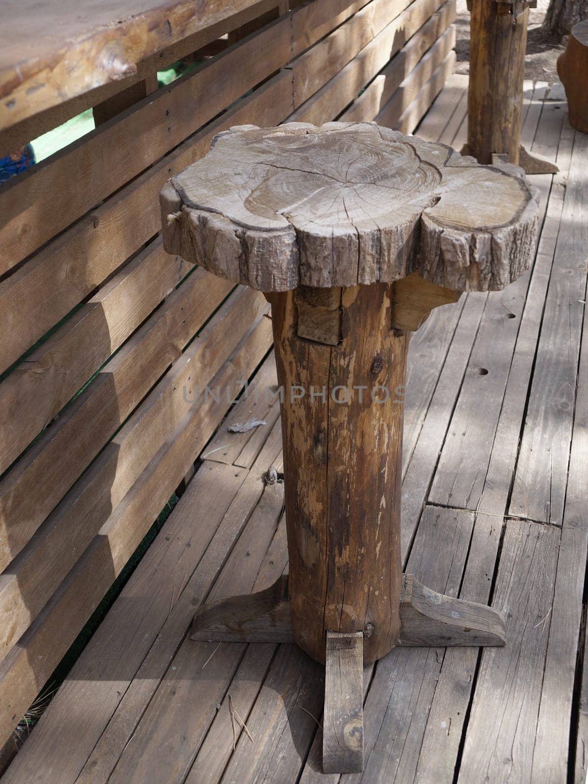 rustic handcrafted wooden bar stool on outdoor terrace by Annado