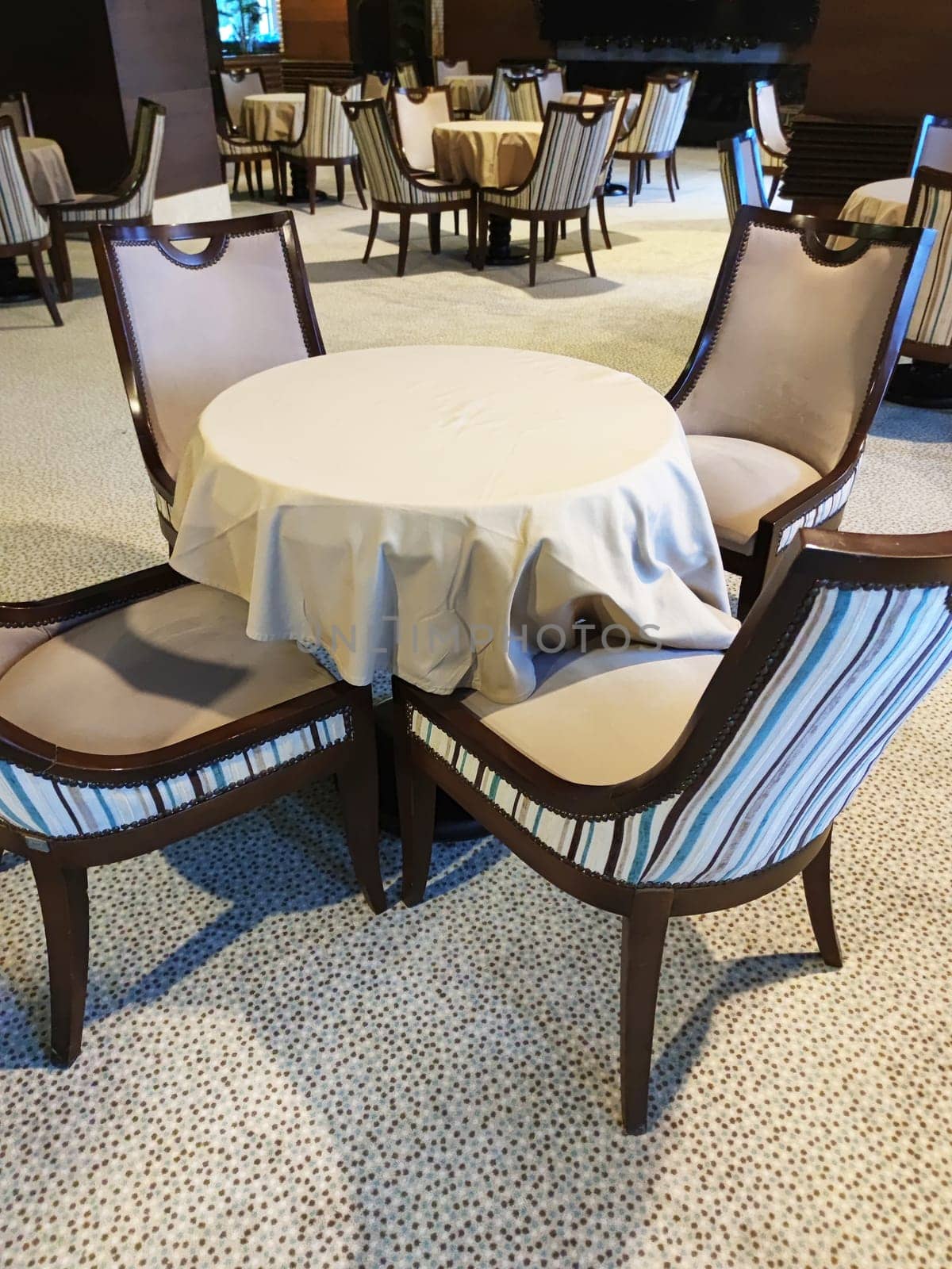 elegant dining chairs and round table in restaurant interior by Annado