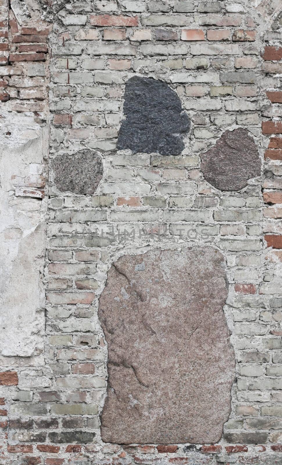 Vertical photo of a wall made of bricks and stones. by gelog67