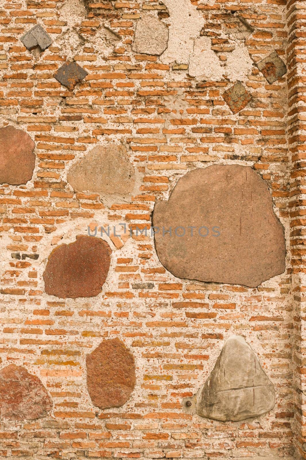 Medieval wall made of bricks and stone. Abstract background.